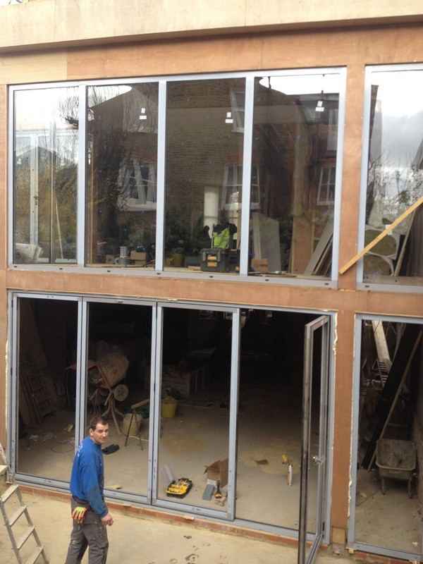 Aluminium bi-fold doors with two-storey glazing in Purley