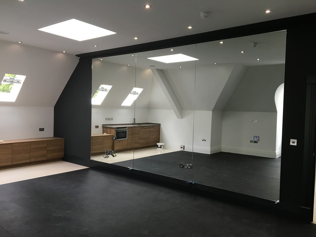 Frameless glass wall dividing loft conversion in Purley