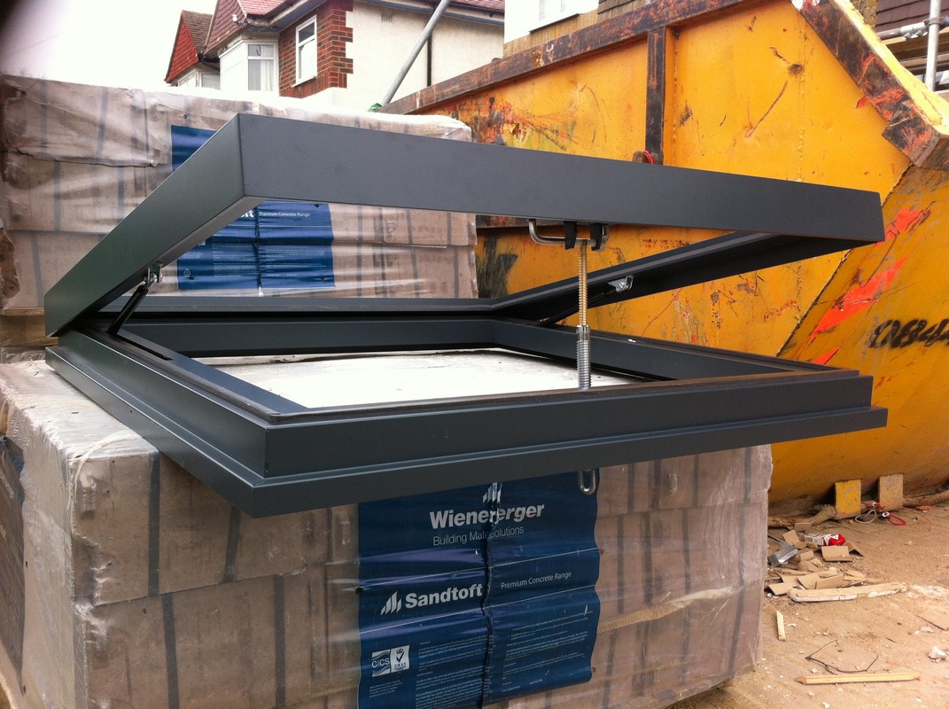 Opening flat roof skylight in anthracite grey installed in Purley